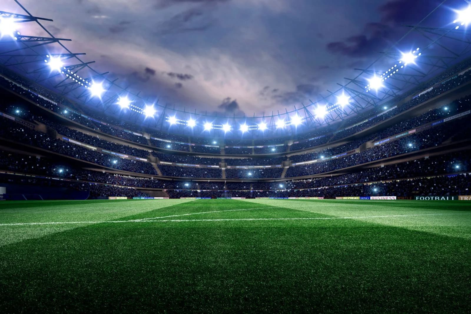 Estadio de fútbol iluminado visto desde el campo